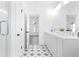 Elegant bathroom with double vanity, quartz countertops, tiled floors, and glass-enclosed shower at 3319 Stillwood Ln, Hapeville, GA 30354
