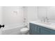 Bathroom featuring a blue vanity with white countertop, white subway tile, and a bathtub with shower at 3319 Stillwood Ln, Hapeville, GA 30354