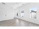 Bright and airy bedroom with hardwood floors, white walls, and plenty of natural light from multiple windows at 3319 Stillwood Ln, Hapeville, GA 30354
