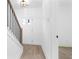 Staircase with white risers and dark metal balusters leads to a brightly lit front door at 3319 Stillwood Ln, Hapeville, GA 30354