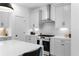 Stylish kitchen featuring stone backsplash, stainless hood, and shaker cabinets at 3319 Stillwood Ln, Hapeville, GA 30354