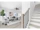 Bright living room with neutral tones, modern furnishings, and a staircase with gray and black accents at 3319 Stillwood Ln, Hapeville, GA 30354