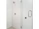 Close-up of a glass-enclosed shower showcasing tiled walls, modern fixtures, and a sleek design at 3319 Stillwood Ln, Hapeville, GA 30354