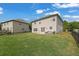 Spacious backyard with green lawn, fence, and patio seating area, great for outdoor activities at 4050 Pleasant Woods Dr, Cumming, GA 30028