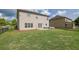 Large fenced backyard with manicured lawn, covered porch, and patio seating area at 4050 Pleasant Woods Dr, Cumming, GA 30028