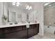 Bathroom featuring double sink vanity with dark cabinets, neutral walls and tile, and separate tub area at 4050 Pleasant Woods Dr, Cumming, GA 30028