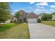 Charming brick home with a well-manicured lawn, two car garage, and a beautifully landscaped front yard at 4050 Pleasant Woods Dr, Cumming, GA 30028