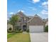 Charming two-story brick home with a well-manicured lawn and attached two car garage at 4050 Pleasant Woods Dr, Cumming, GA 30028