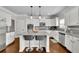Open kitchen features granite counters, an island with seating, and stainless steel appliances at 4050 Pleasant Woods Dr, Cumming, GA 30028