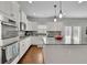 Stylish kitchen features granite counters, gray backsplash, modern appliances, and hardwood floors at 4050 Pleasant Woods Dr, Cumming, GA 30028