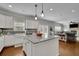 Open kitchen boasts a large island, granite counters, stainless appliances, and easy access to living room at 4050 Pleasant Woods Dr, Cumming, GA 30028