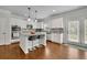 Bright eat-in kitchen with granite counters, an island, stainless appliances, and hardwood flooring at 4050 Pleasant Woods Dr, Cumming, GA 30028