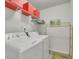 Bright laundry room with front loading washer and dryer and built-in shelving at 4050 Pleasant Woods Dr, Cumming, GA 30028