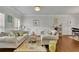 Bright living room features hardwood floors, neutral paint, and wainscoting at 4050 Pleasant Woods Dr, Cumming, GA 30028