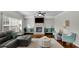 Inviting living room features a brick fireplace, large windows, comfortable seating, and stylish decor at 4050 Pleasant Woods Dr, Cumming, GA 30028