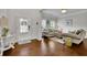 Inviting living room features hardwood floors, neutral paint, and bright natural light from the large windows at 4050 Pleasant Woods Dr, Cumming, GA 30028
