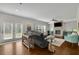 Bright living room features a brick fireplace, stylish decor, and sliding glass doors to the outside at 4050 Pleasant Woods Dr, Cumming, GA 30028