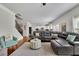Bright living room features hardwood floors, gray sectional sofa and white trim at 4050 Pleasant Woods Dr, Cumming, GA 30028