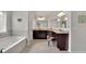 The main bathroom boasts a double vanity, dark cabinets, granite countertops, and tub at 4050 Pleasant Woods Dr, Cumming, GA 30028