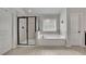 Main bathroom features a tub, glass shower, and tile floors at 4050 Pleasant Woods Dr, Cumming, GA 30028