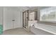 Main bathroom features a tub, glass shower, and tile floors at 4050 Pleasant Woods Dr, Cumming, GA 30028