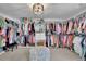 Spacious walk-in closet featuring custom shelving, ample hanging space, and stylish overhead lighting at 4050 Pleasant Woods Dr, Cumming, GA 30028
