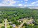 Expansive aerial view of the neighborhood with lush greenery and lake views at 4525 E Point Dr, Cumming, GA 30041