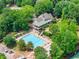 Aerial view of the neighborhood pool and tennis courts surrounded by trees at 4525 E Point Dr, Cumming, GA 30041