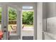 View from kitchen doorway of a serene backyard with lush greenery and a deck at 4525 E Point Dr, Cumming, GA 30041