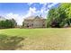 A well-manicured backyard featuring a large lawn, a deck, and rear exterior at 4525 E Point Dr, Cumming, GA 30041