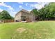 Spacious backyard featuring a well-maintained lawn, mature trees, and a wooden deck at 4525 E Point Dr, Cumming, GA 30041