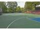 Community basketball court with well-maintained surface and surrounding fence and green landscaping at 4525 E Point Dr, Cumming, GA 30041