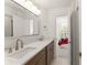 Bright bathroom features dual sinks, marble countertop, and a view into a bright bedroom at 4525 E Point Dr, Cumming, GA 30041