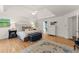 Spacious bedroom featuring hardwood floors, a tray ceiling, and elegant furnishings at 4525 E Point Dr, Cumming, GA 30041