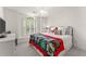 Bright bedroom with a full-sized bed, a modern chandelier and shuttered windows at 4525 E Point Dr, Cumming, GA 30041