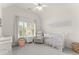 Bright Bedroom with a crib and a window at 4525 E Point Dr, Cumming, GA 30041