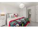 Cozy bedroom featuring a comfortable bed, modern chandelier and shuttered windows at 4525 E Point Dr, Cumming, GA 30041