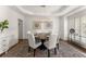 A bright dining room features a tray ceiling, stylish light fixture, and six chairs around a wood table at 4525 E Point Dr, Cumming, GA 30041