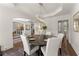 An elegant dining room with a round table, white chairs, and an ornate light fixture at 4525 E Point Dr, Cumming, GA 30041