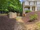 View of a driveway entrance leading up to the side of a two-story house at 4525 E Point Dr, Cumming, GA 30041