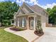 Side view of a brick home with a well-manicured lawn, walkway, and neatly trimmed landscaping at 4525 E Point Dr, Cumming, GA 30041