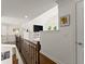 Upstairs hallway featuring a view into the bonus room and an overlooking banister at 4525 E Point Dr, Cumming, GA 30041