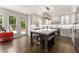 Spacious kitchen with an island seating, white cabinetry, stainless steel appliances, and access to the backyard at 4525 E Point Dr, Cumming, GA 30041
