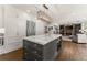 Spacious kitchen featuring a marble island, stainless steel refrigerator, and open view to the living room at 4525 E Point Dr, Cumming, GA 30041