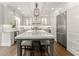 Well-appointed kitchen features a central island with a marble countertop and seating at 4525 E Point Dr, Cumming, GA 30041