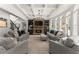 Elegant living room features coffered ceilings, stone fireplace, built-in shelving, and large arched windows at 4525 E Point Dr, Cumming, GA 30041