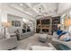 Beautiful living room boasts a stone fireplace, built-in shelving, and views of the staircase at 4525 E Point Dr, Cumming, GA 30041