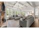 Bright living room with coffered ceilings, fireplace, hardwood floors, and seamless flow to the kitchen at 4525 E Point Dr, Cumming, GA 30041