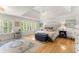 Bright main bedroom featuring a decorative rug, hard wood floors, and tray ceiling at 4525 E Point Dr, Cumming, GA 30041