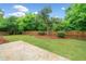 A well-maintained backyard features lush greenery, a stone patio, and a privacy fence at 508 Canton Ct, Canton, GA 30115
